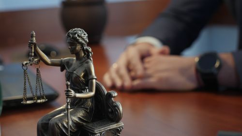 Statue of justice on a table against the background of a judge Lady Justice - Criminal & DUI Law of Georgia