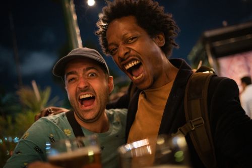 Two drunk men celebrating outdoors- 